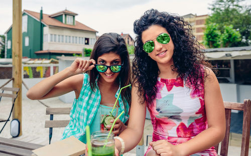 Female friends having drinks at table