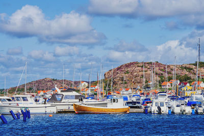 Sailboats moored in sea against sky