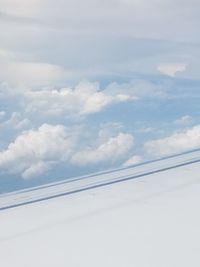 Low angle view of airplane flying against sky