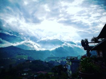Panoramic view of buildings and mountains against sky