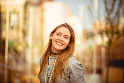 Portrait of smiling young woman standing outdoors