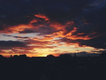 Silhouette of landscape against cloudy sky