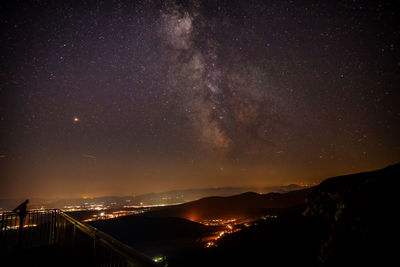 Scenic view of illuminated mountains against sky at night