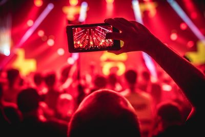 Man photographing crowd at music concert