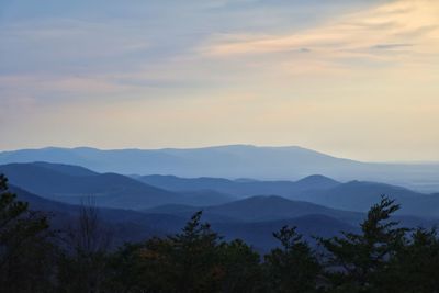 Scenic view of mountains against sky at sunset