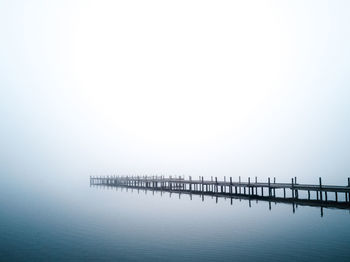 High angle view of pier on lake against sky