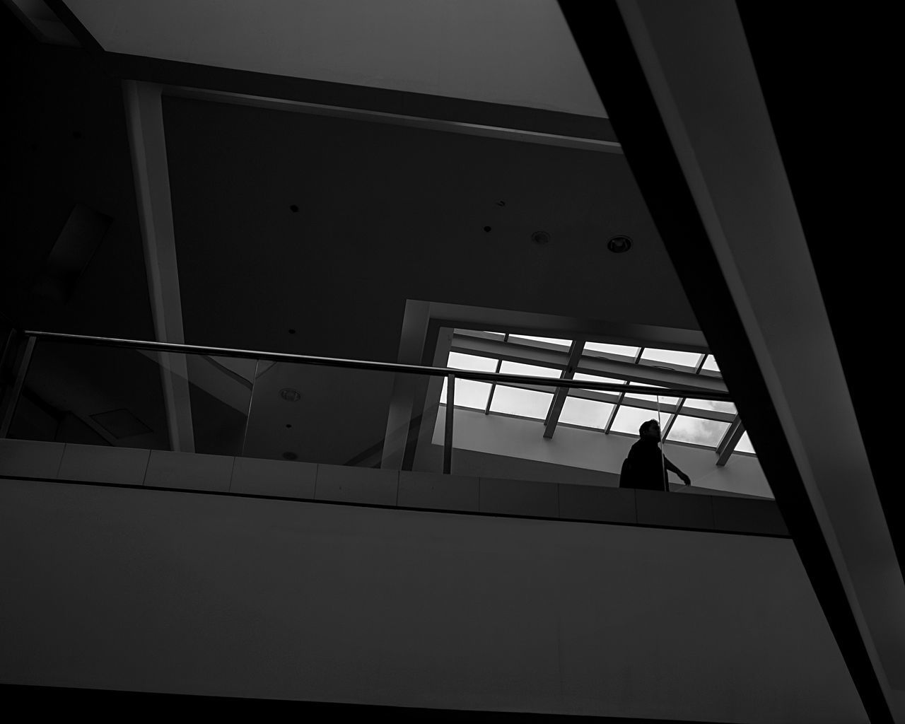 LOW ANGLE VIEW OF MAN MOVING UP ON WINDOW