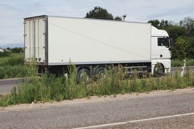 Vehicles on road against the sky