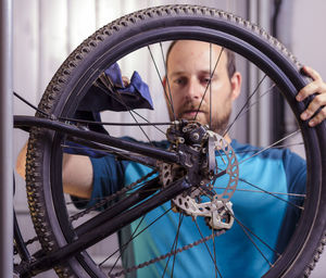 Man cleaning bicycle wheel