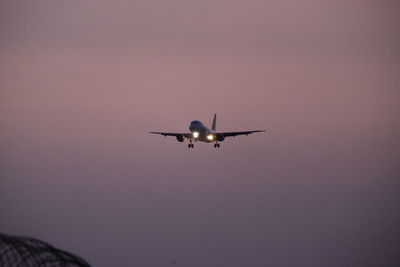 Low angle view of airplane flying against sky