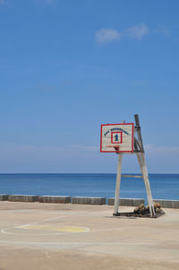 Lifeguard hut at beach against sky