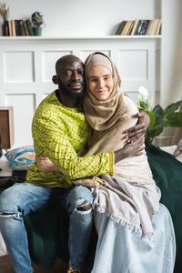 Couple embracing on bed at home