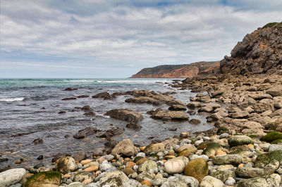 Rocks in sea against sky