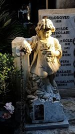 Statue of buddha against wall