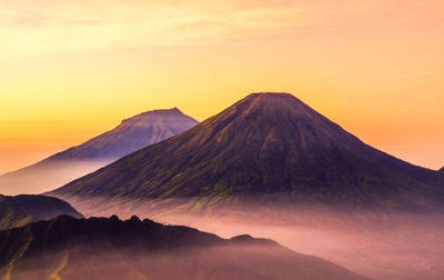 Scenic view of mountain range against sky during sunset