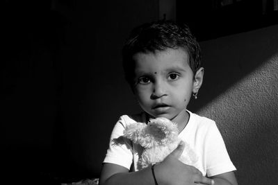 Portrait of boy holding toy