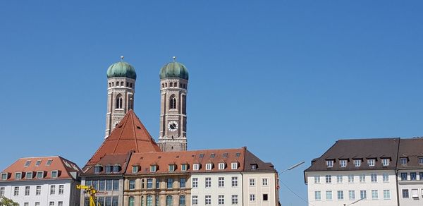 Low angle view of buildings against clear blue sky