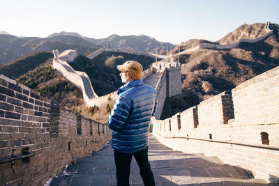 Rear view of man standing on steps at great wall of china