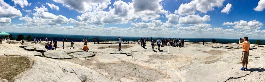 People at beach against sky