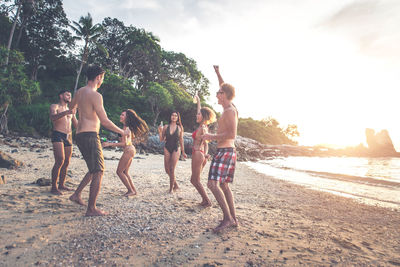 Friends enjoying at beach during summer