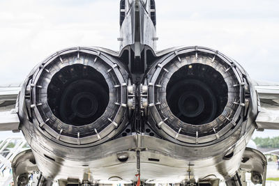 Close-up of airplane on building against sky