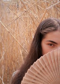 Portrait of a beautiful young woman covering face