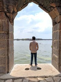 Rear view of man looking at sea