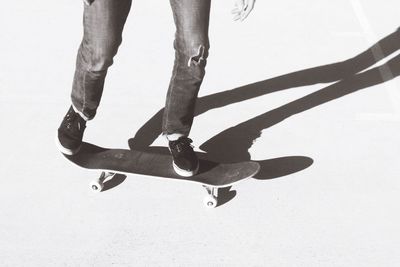 Low section of person walking on skateboard