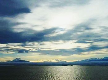 Scenic view of mountains against cloudy sky