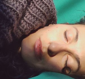 Close-up portrait of woman lying down