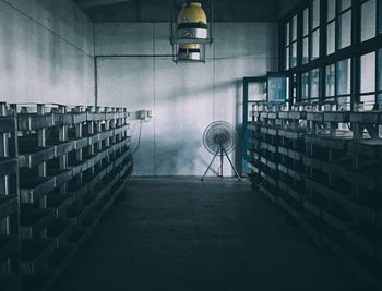 Empty chairs against wall in building