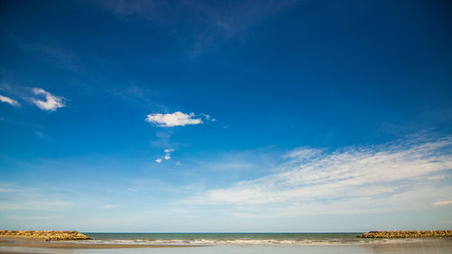 Scenic view of sea against blue sky