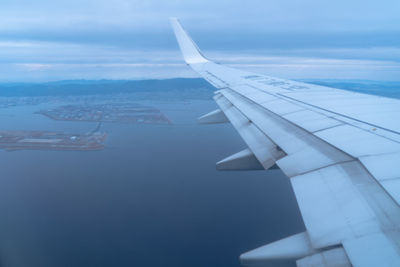 Aerial view of airplane flying in sky