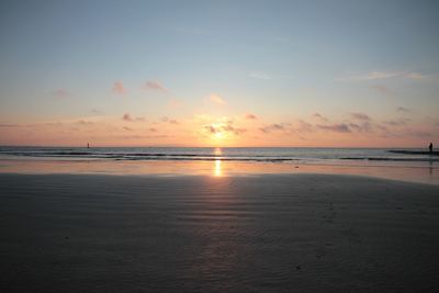 Scenic view of beach against sky during sunset