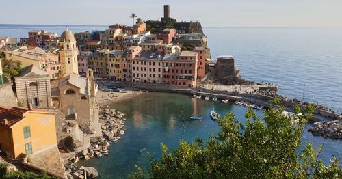 High angle view of townscape by sea against sky