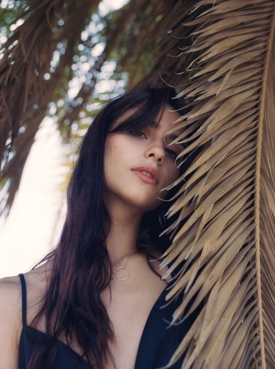 portrait, one person, hair, real people, smiling, headshot, leisure activity, long hair, hairstyle, lifestyles, young adult, young women, women, front view, plant, happiness, looking, looking at camera, beautiful woman, outdoors