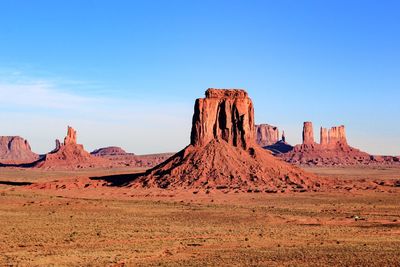 Scenic view of monument valley against blue sky