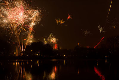 Low angle view of firework display at night