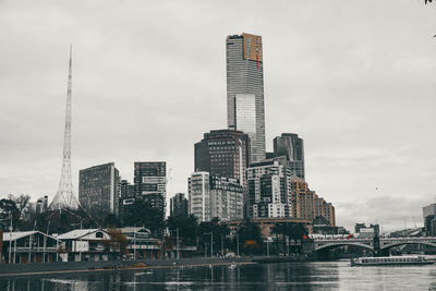 View of skyscrapers against cloudy sky