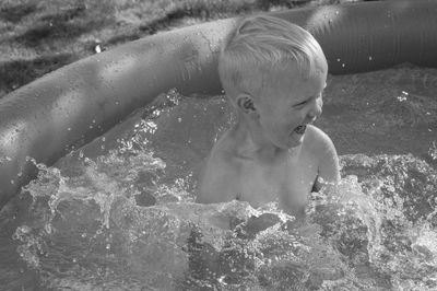 Full length of shirtless boy in swimming pool