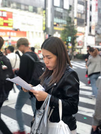 Women standing on street in city