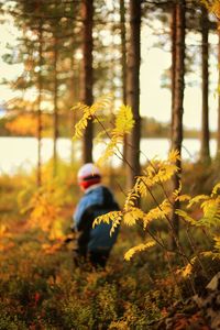 Man riding motorcycle in forest during autumn