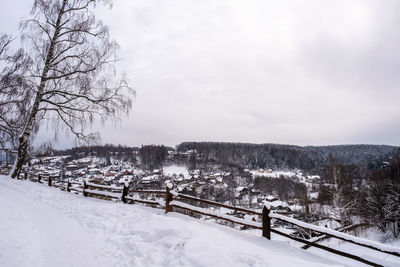 Scenic view of snow covered field against sky