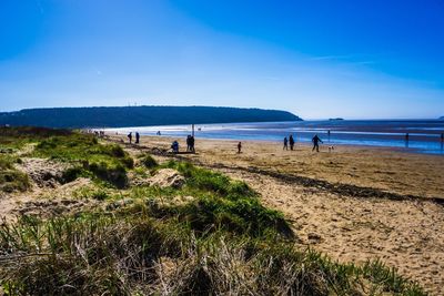 Scenic view of beach against blue sky