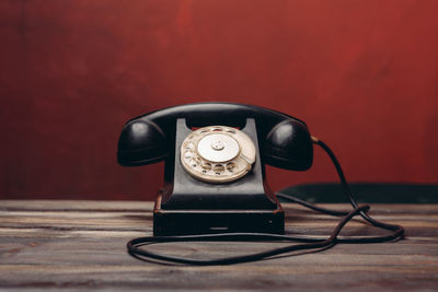 Close-up of vintage telephone on table