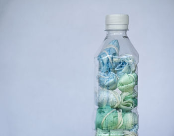 Close-up of glass bottle against white background