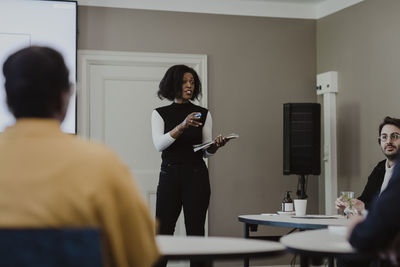 Female entrepreneur explaining in meeting at corporate office