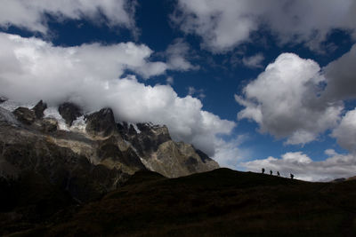 Scenic view of mountains against cloudy sky