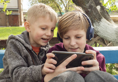 Portrait of boy holding mobile phone