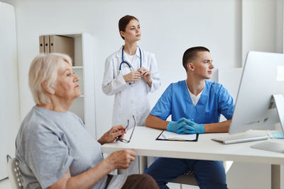 Friends sitting on table at home